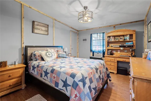 a bedroom with a bed and a chandelier