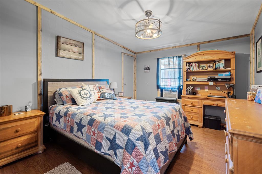 7201 Northeast 132nd Place Citra, FL 32113 - Photo 16 of 37 a bedroom with a bed and a chandelier