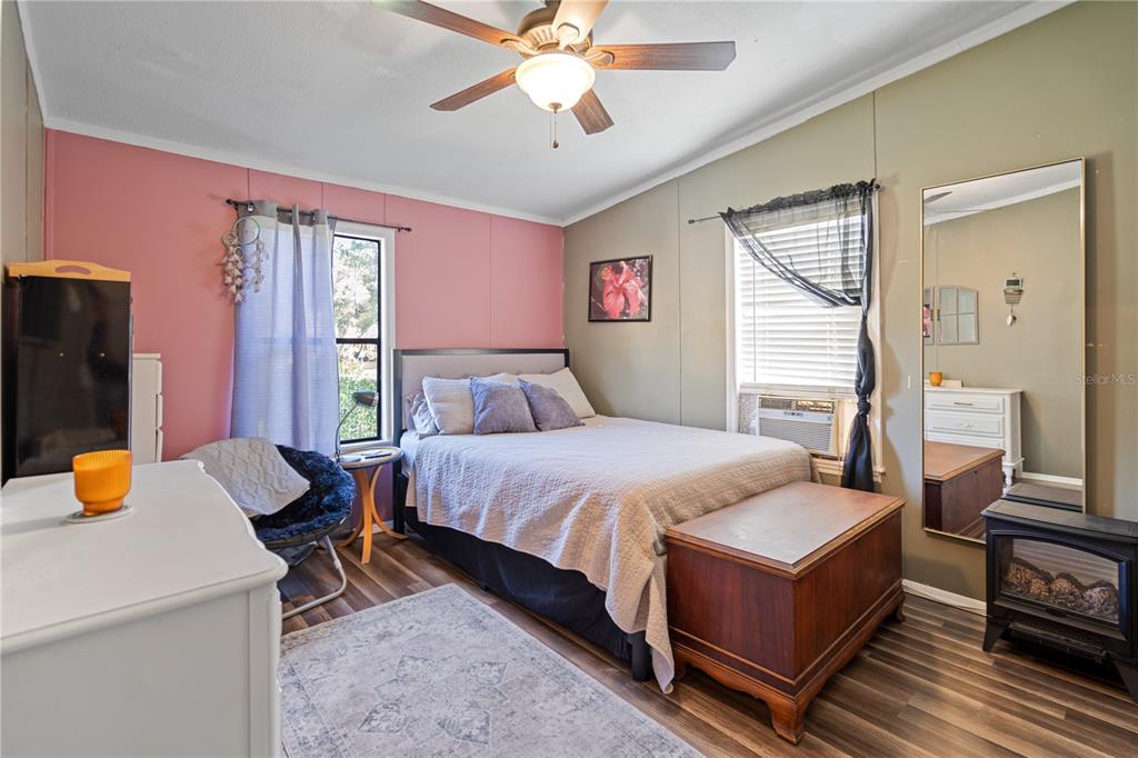 7201 Northeast 132nd Place Citra, FL 32113 - Photo 18 of 37 a bedroom with a bed and a chandelier