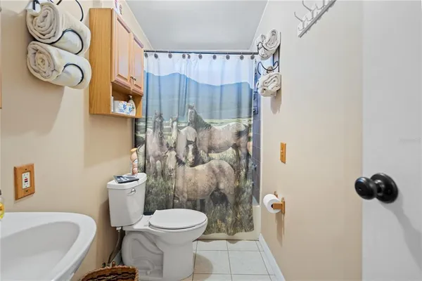 a white toilet sitting next to a bathroom sink