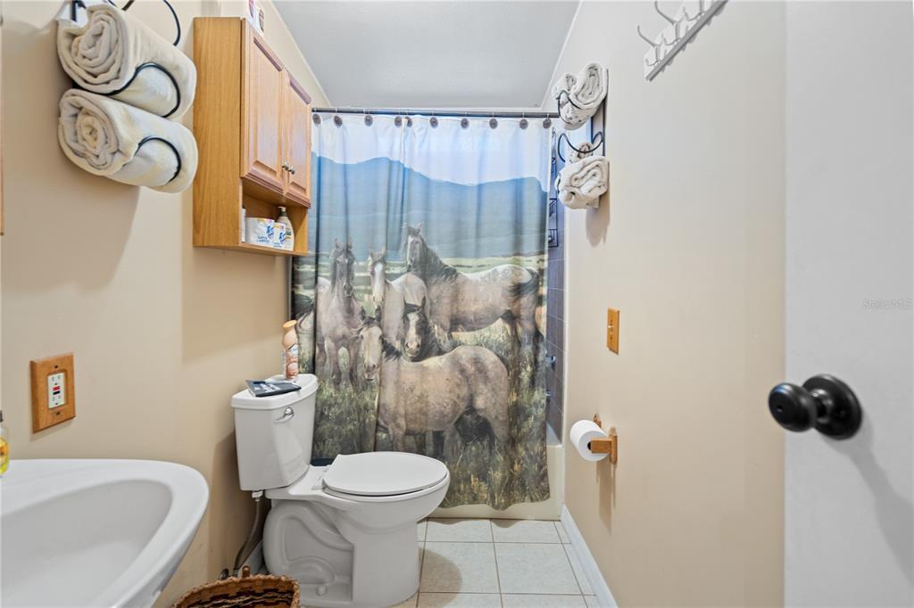 7201 Northeast 132nd Place Citra, FL 32113 - Photo 19 of 37 a white toilet sitting next to a bathroom sink