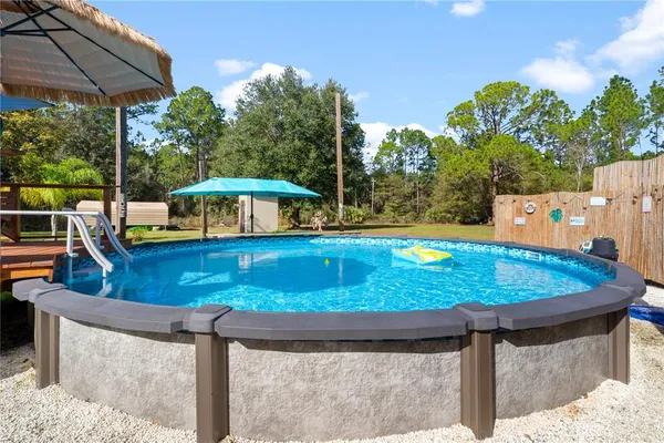 swimming pool view with a seating space