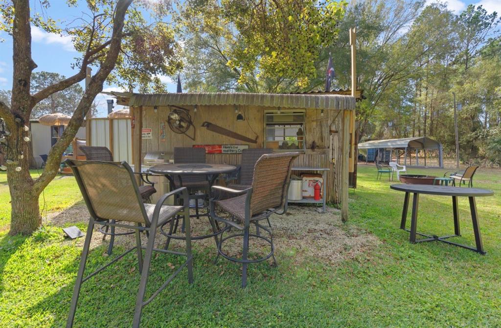 7201 Northeast 132nd Place Citra, FL 32113 - Photo 27 of 37 a view of a chairs and table in backyard