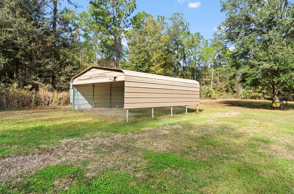 7201 Northeast 132nd Place Citra, FL 32113 - Photo 29 of 37 a backyard of a house with table and chairs