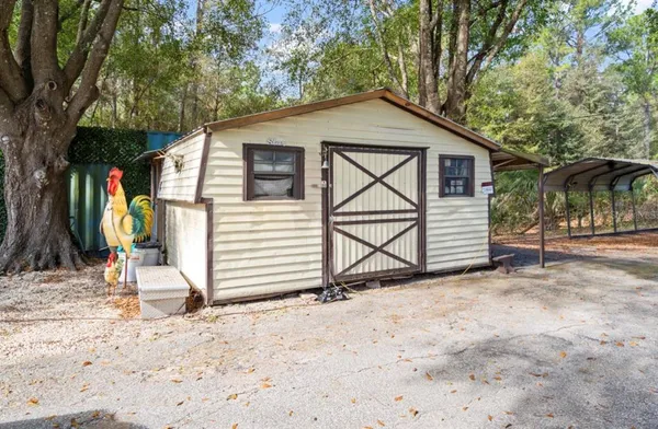 a backyard of a house with table and chairs
