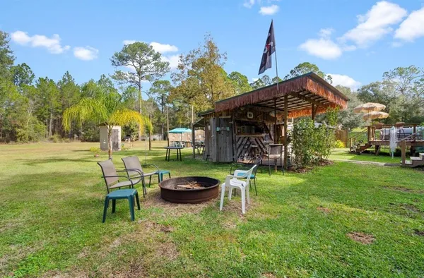 a view of a house with patio and a yard