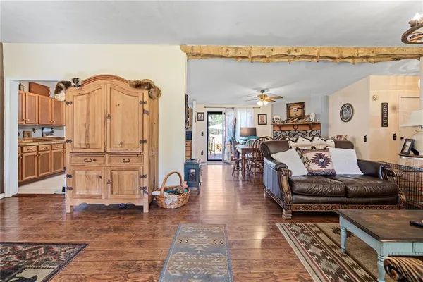 a living room with furniture a table and white walls