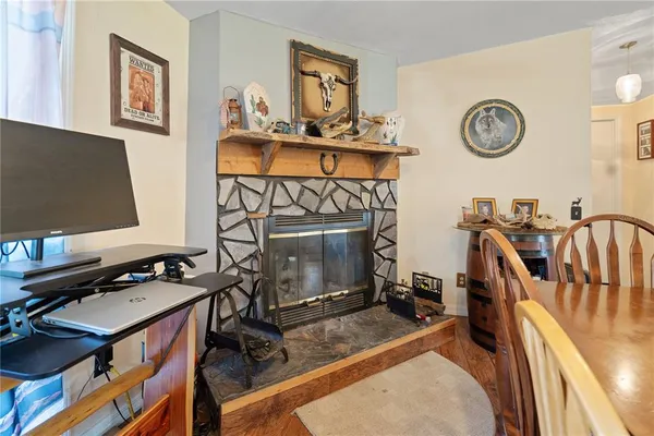 a view of a workspace with furniture and a fireplace