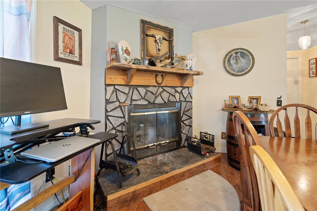 7201 Northeast 132nd Place Citra, FL 32113 - Photo 8 of 37 a view of a workspace with furniture and a fireplace