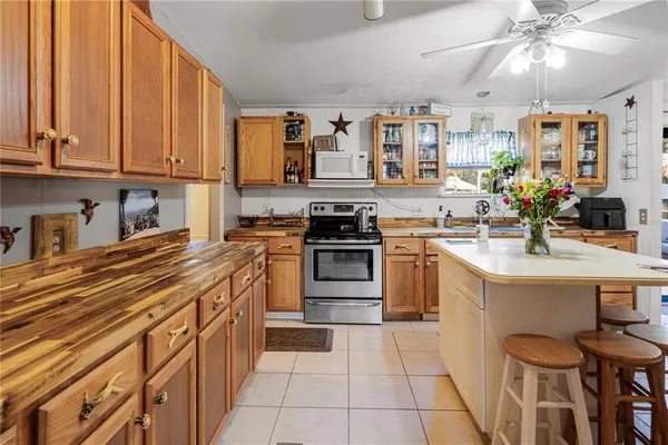 a kitchen with stainless steel appliances a stove sink and cabinets