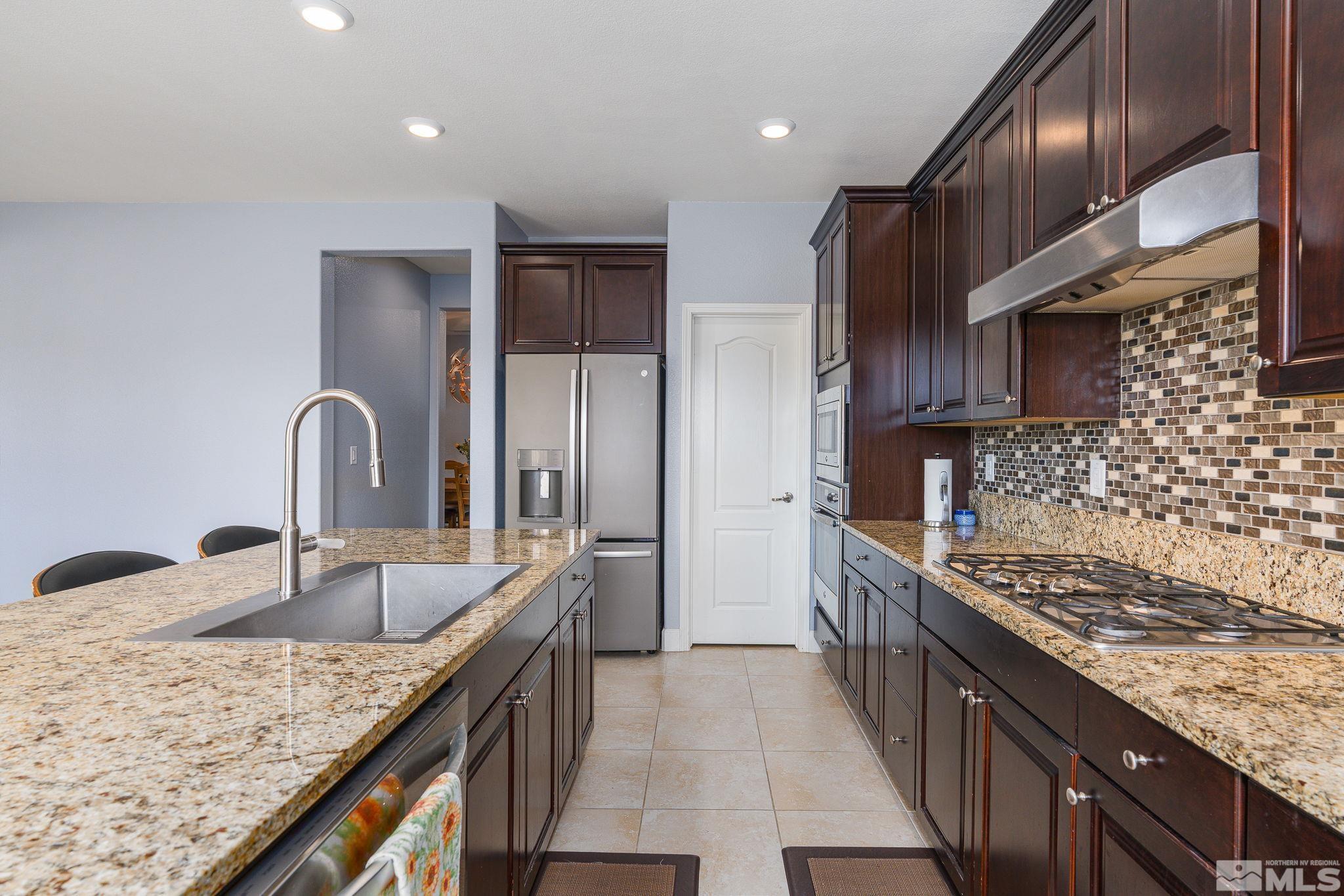 1665 Scott Valley Road Reno, NV 89523 - Photo 16 of 40 a kitchen with stainless steel appliances granite countertop a sink stove and cabinets