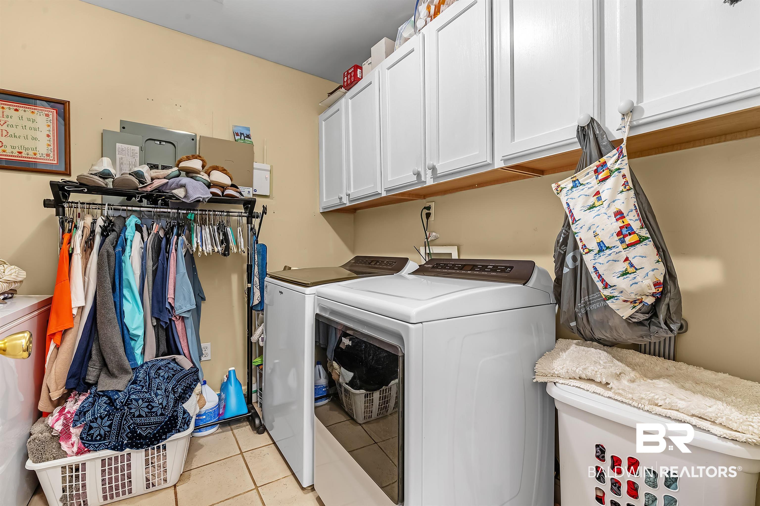 9901 Glover Court Fairhope, AL 36532 - Photo 16 of 52 Laundry area with separate washer and dryer, cabinets, and light tile patterned floors