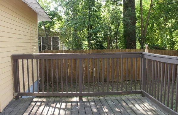 a view of balcony with wooden floor and outdoor seating
