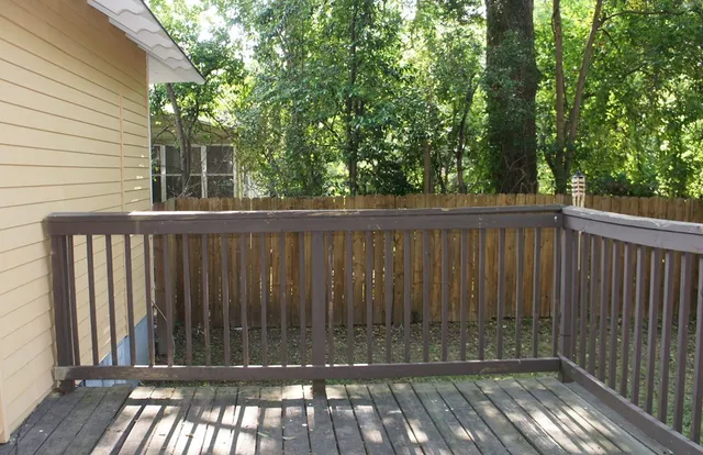 a view of balcony with wooden floor and outdoor seating