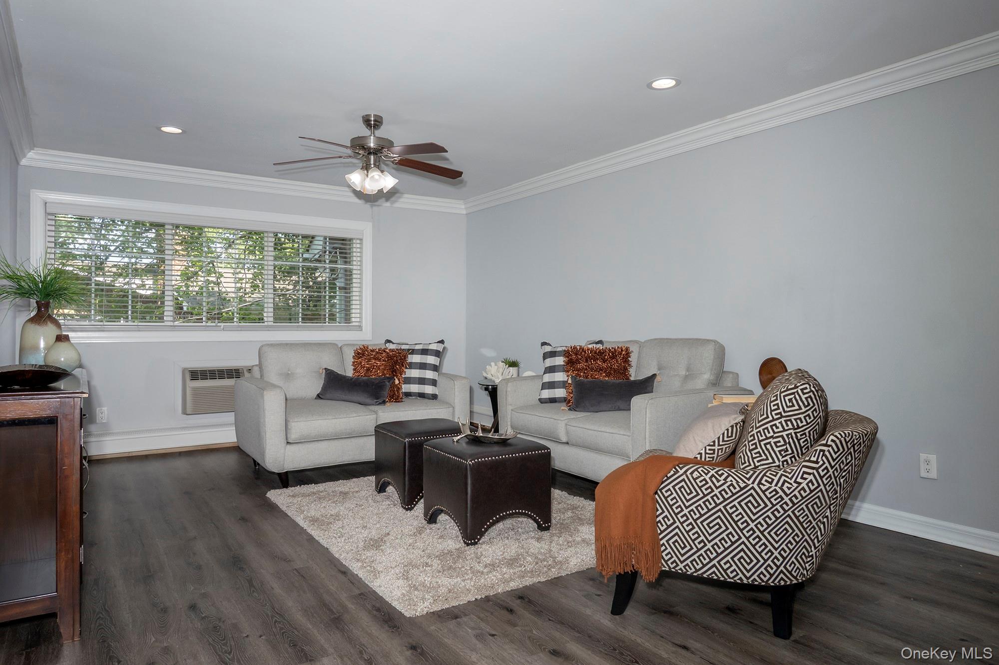 70 Middleton Road, Unit SF05 Bohemia, NY 11716 - Photo 5 of 9 a living room with furniture and a chandelier