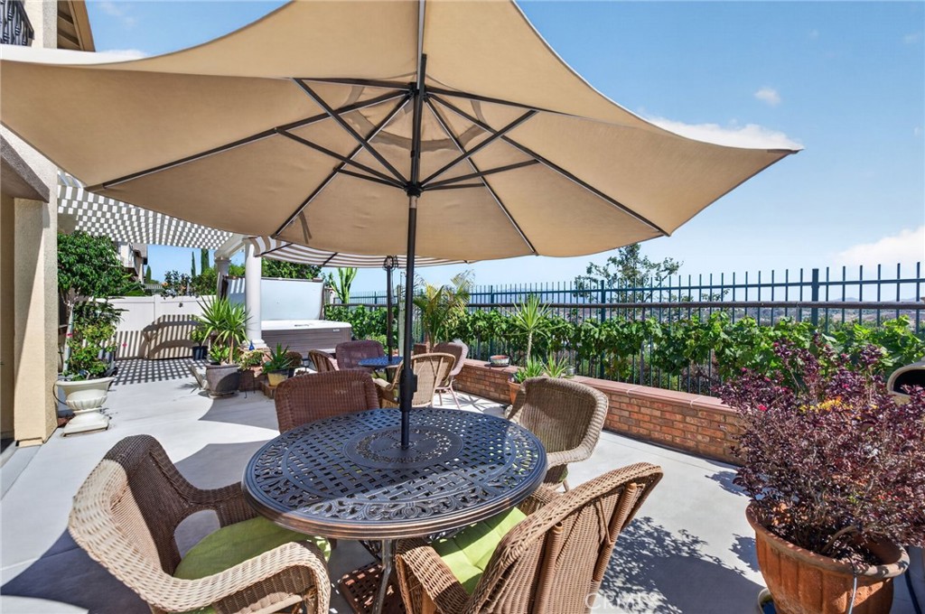 31749 Country View Road Temecula, CA 92591 - Photo 47 of 68 a patio with a patio table and chairs