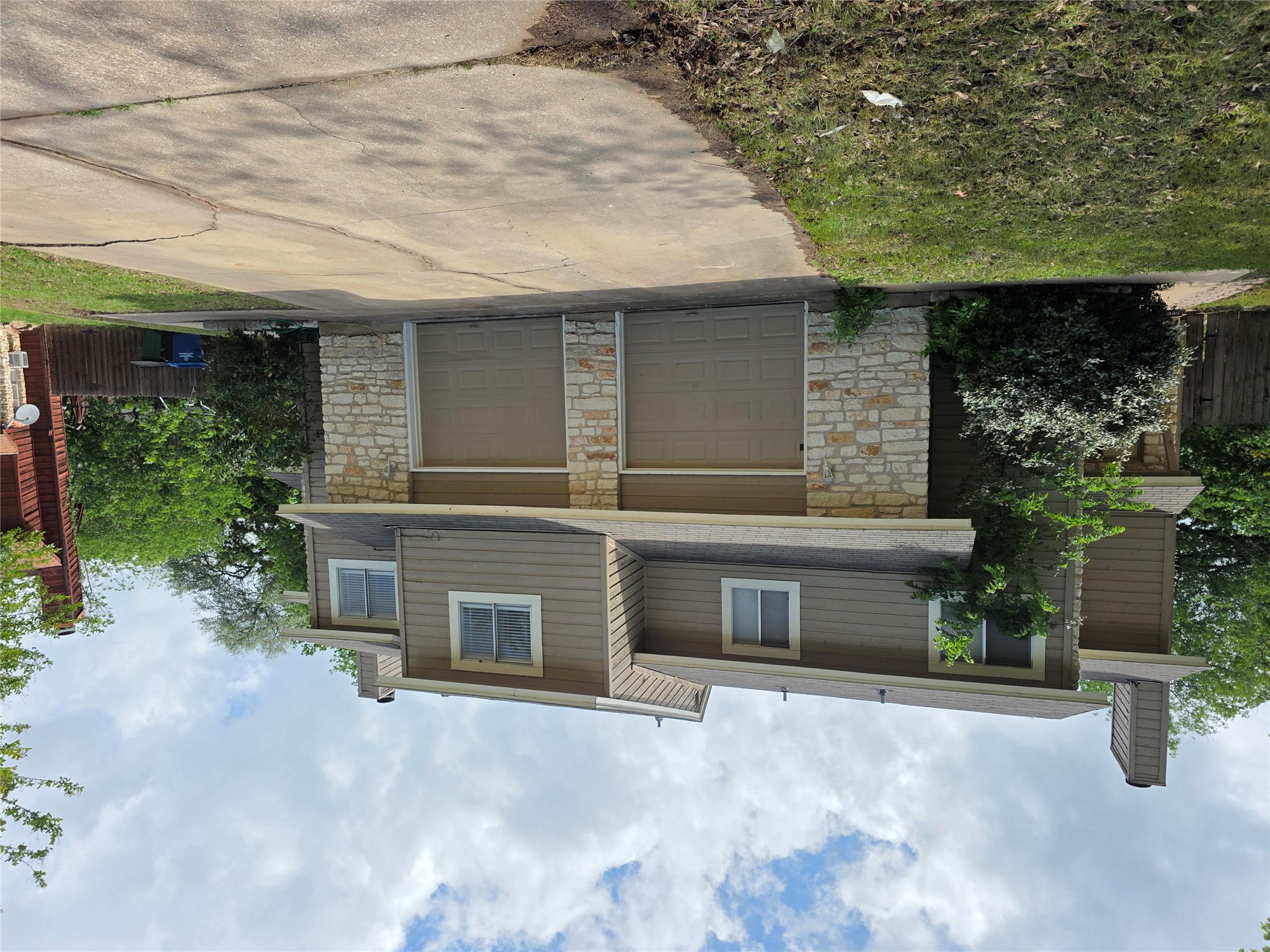 8818 Clearbrook Trail Austin, TX 78729 - Photo 2 of 22 Front Facade of 8818 Clearbrook Trail, the brush on Unit B (left) side has been trimmed