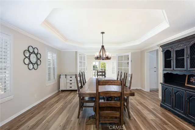 a dining room with furniture window and wooden floor