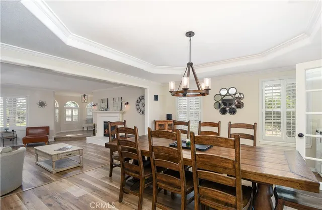 a view of a dining room with furniture wooden floor and chandelier