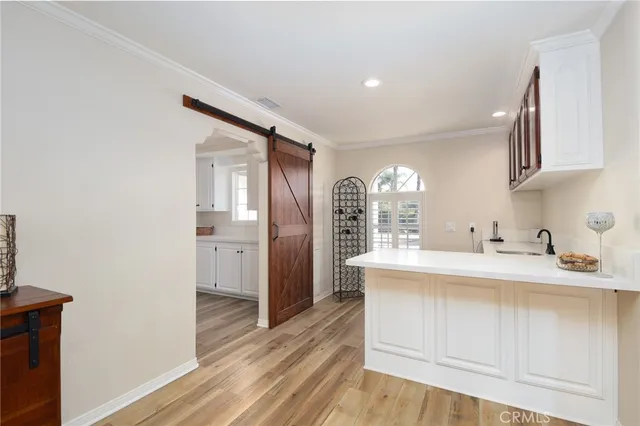 a kitchen with a sink cabinets stainless steel appliances and a window