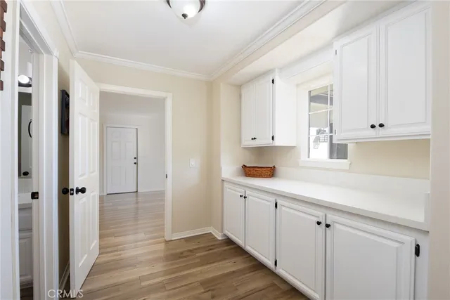 a view of a kitchen with white cabinets