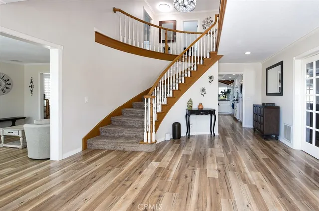 a view of entryway and hall with wooden floor