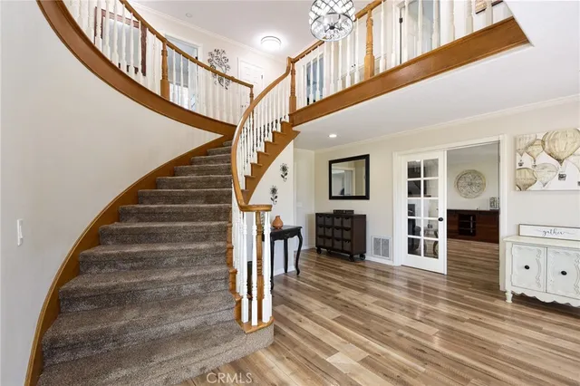 a view of entryway and hall with wooden floor