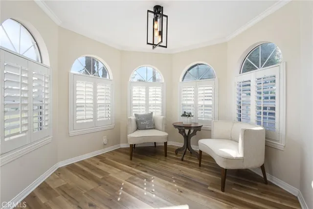 a living room with furniture and two windows