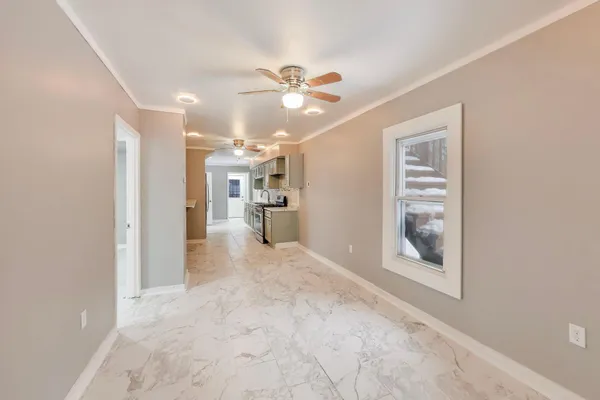 a view of a hallway with a kitchen