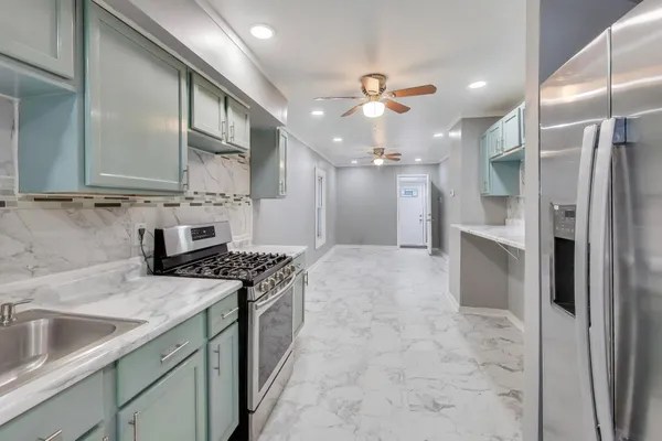 a kitchen with a sink appliances and cabinets