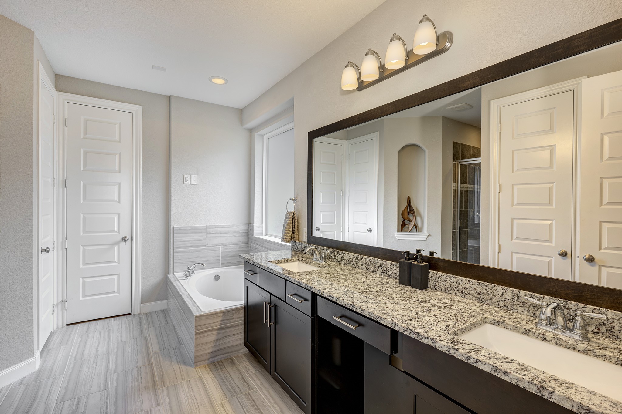 5002 Harvest Knoll Drive Spring, TX 77389 - Photo 20 of 48 Primary Bathroom with double sinks and vanity, soaking tub and separate walk-in shower.