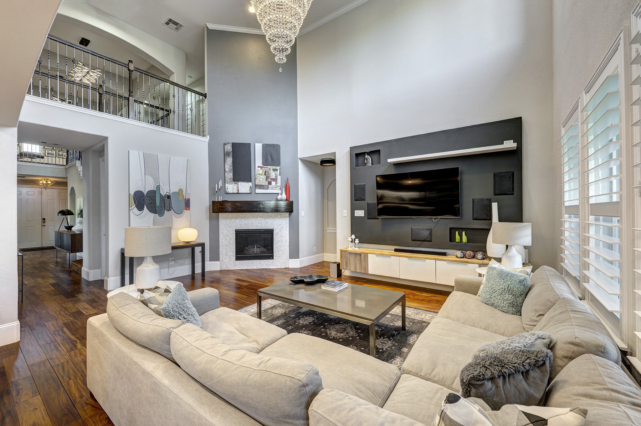 5002 Harvest Knoll Drive Spring, TX 77389 - Photo 8 of 48 2 Story Family Room off the Kitchen featuring a remote gas log fireplace, custom built media, Plantation Shutters and stunning crystal chandelier.
