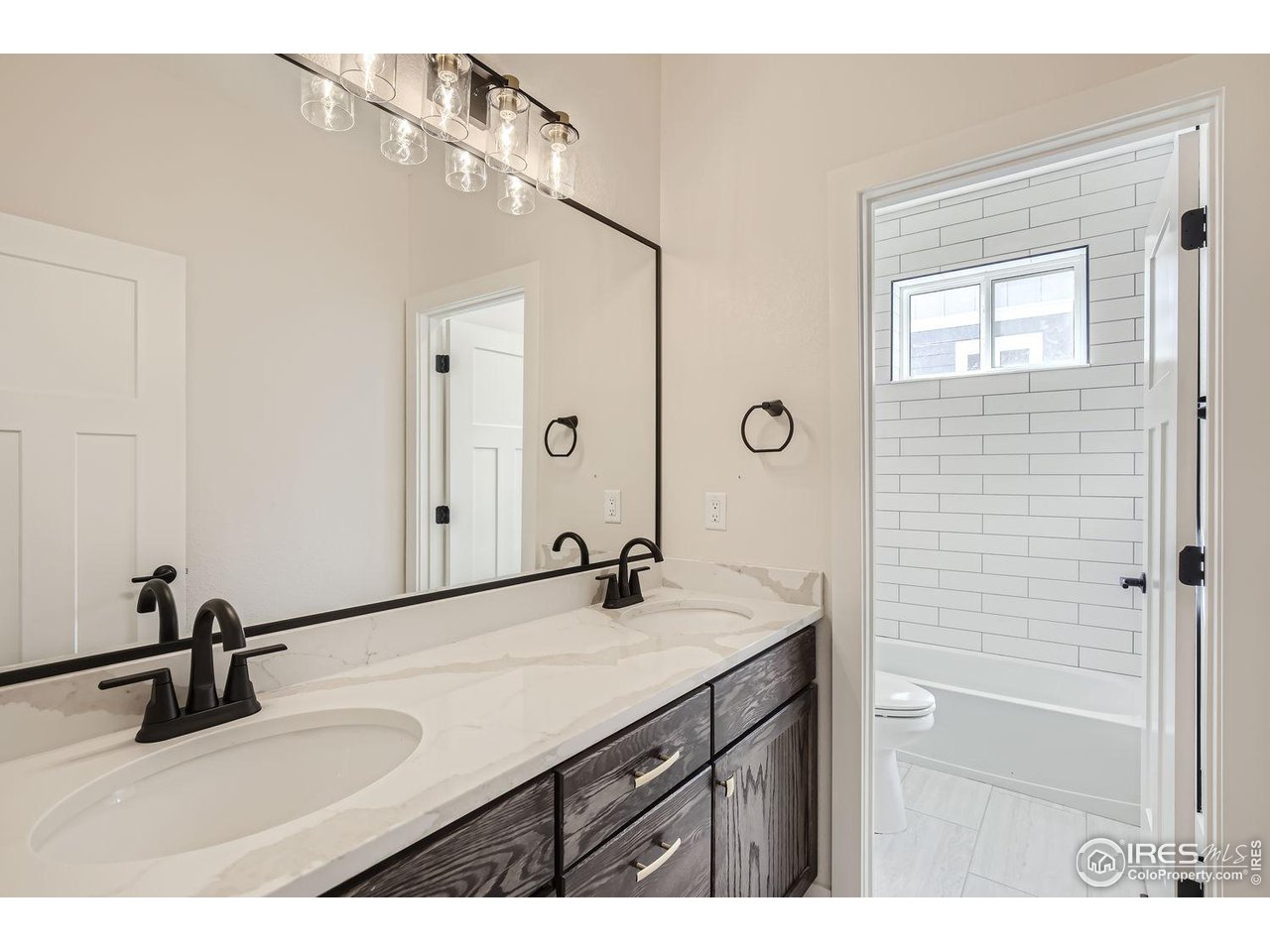 345 Central Avenue Severance, CO 80550 - Photo 10 of 10 a bathroom with a sink and a mirror