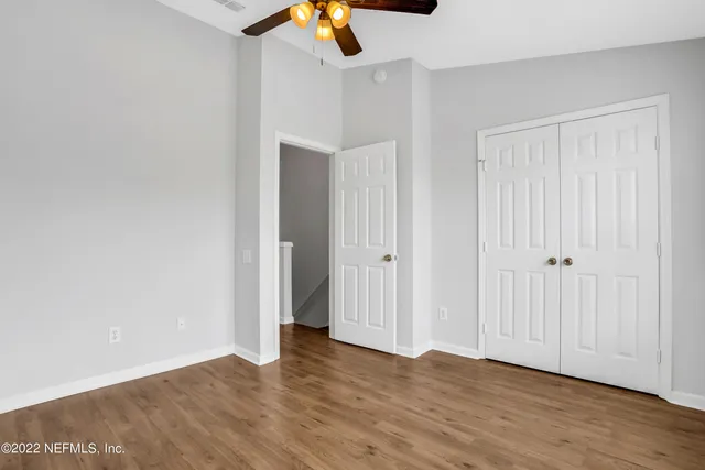a view of an empty room with wooden floor