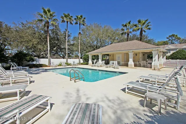 a view of a house with swimming pool and sitting area