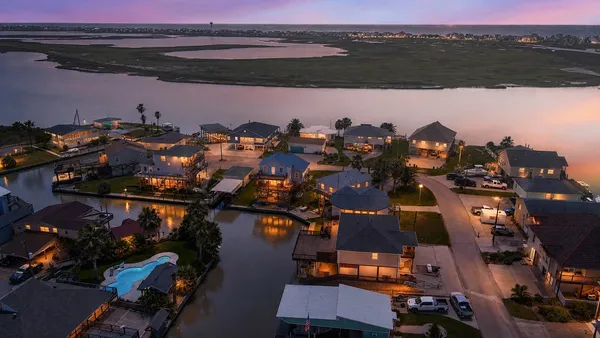 an aerial view of a houses with a lake view