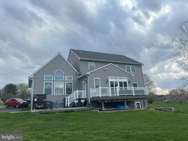 a front view of a house with a garden and deck