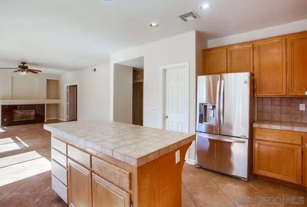 5163 Riverview Court Fallbrook, CA 92028 - Photo 16 of 75 a kitchen with kitchen island a counter top space cabinets and stainless steel appliances