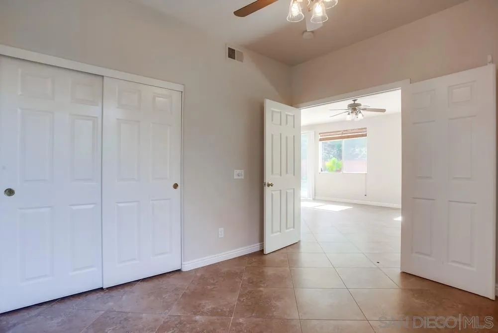5163 Riverview Court Fallbrook, CA 92028 - Photo 20 of 75 a view of an empty room and chandelier fan