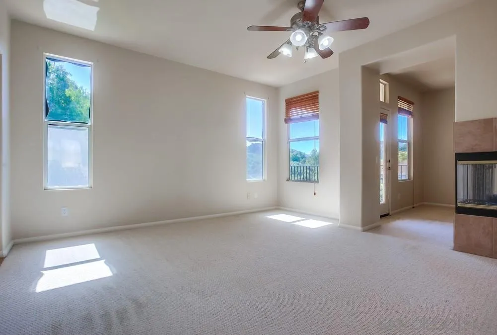 5163 Riverview Court Fallbrook, CA 92028 - Photo 29 of 75 an empty room with windows and chandelier fan