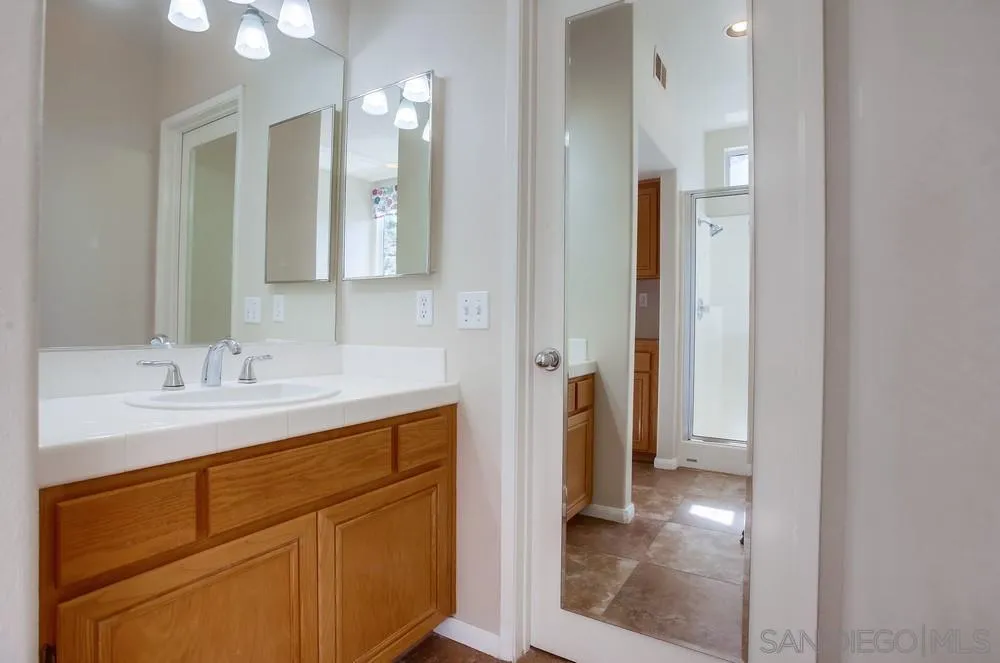5163 Riverview Court Fallbrook, CA 92028 - Photo 38 of 75 a bathroom with a sink and a mirror