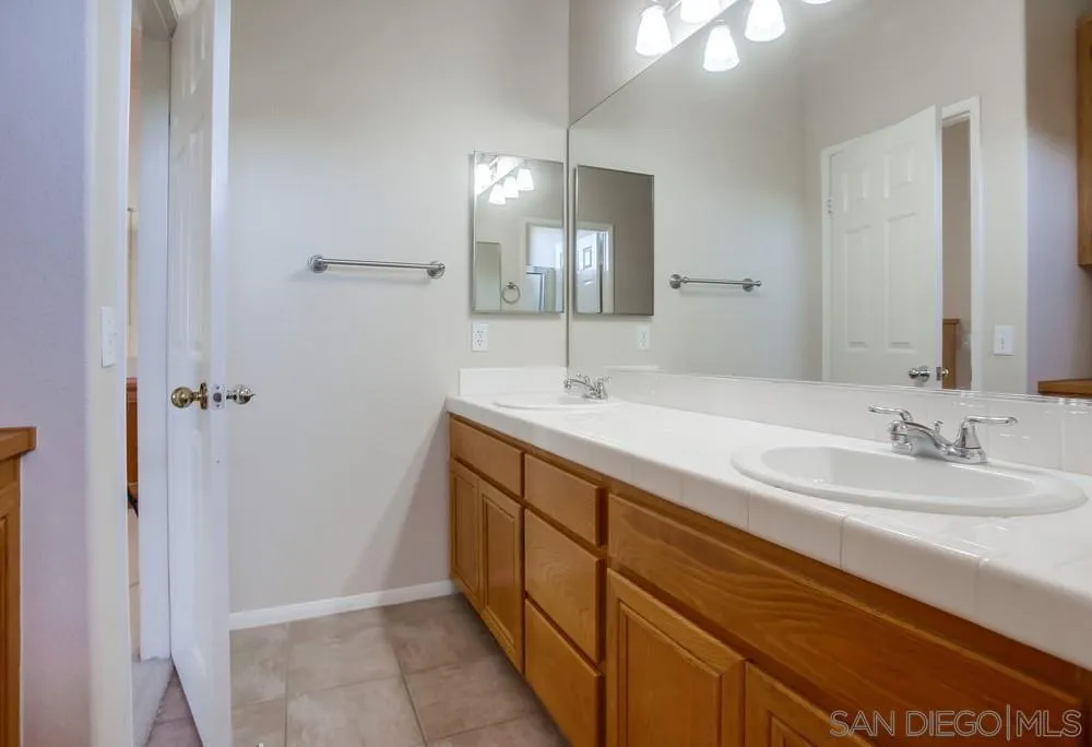 5163 Riverview Court Fallbrook, CA 92028 - Photo 59 of 75 a spacious bathroom with double vanity and a mirror