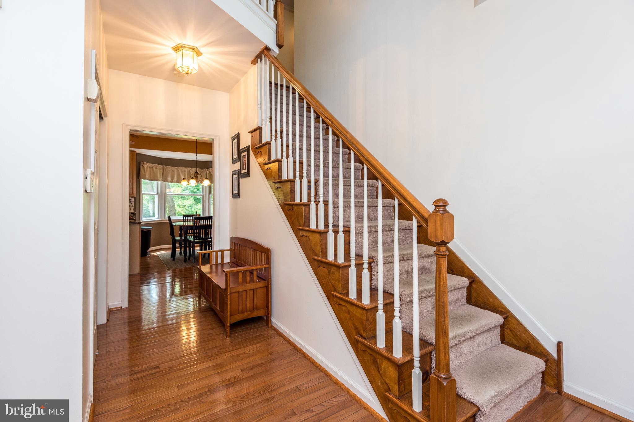 Two Story Foyer with Gleaming Hardwood Flooring