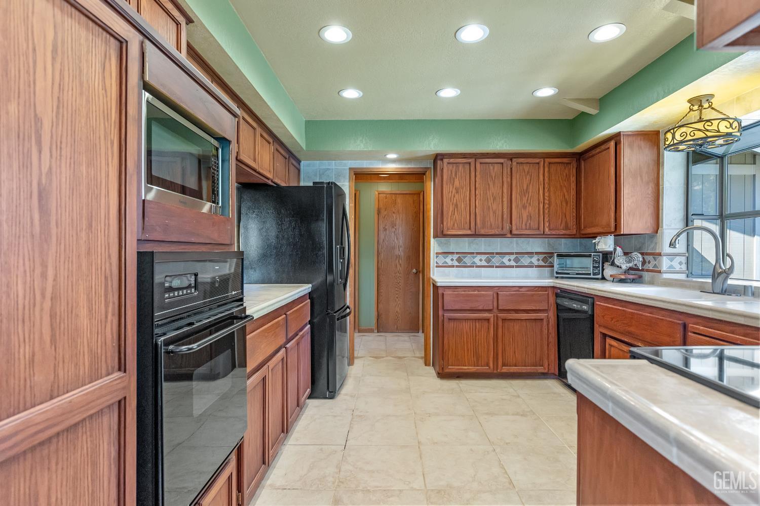 Undisclosed Address Tehachapi, CA 93561 - Photo 18 of 58 a kitchen with stainless steel appliances granite countertop a refrigerator and a stove top oven