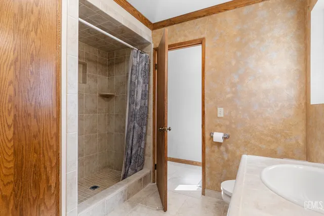 a bathroom with a shower and toilet