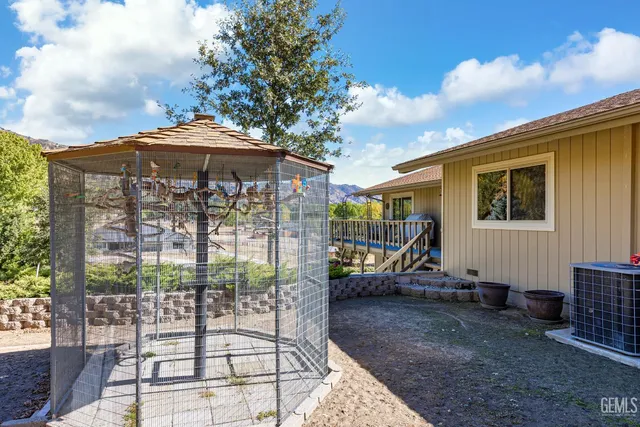 a backyard of a house with barbeque oven table and chairs