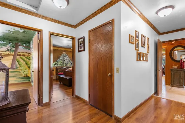 a view of hallway with livingroom and wooden floor
