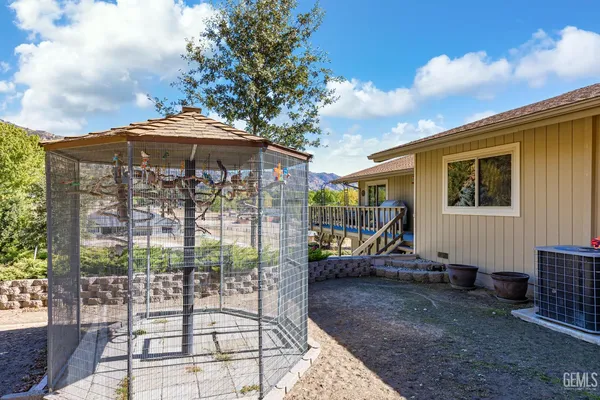 a backyard of a house with barbeque oven table and chairs