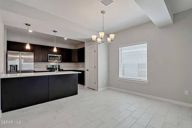 a open kitchen with kitchen island a sink dishwasher a stove and a refrigerator with wooden floor