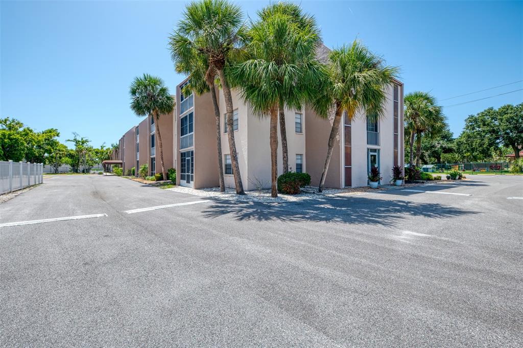 519 Albee Farm Road, Unit 212 Venice, FL 34285 - Photo 1 of 1 front view of house with palm trees